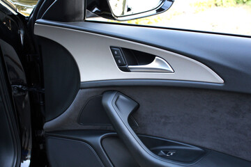 Elegant design of luxury car door trim. Door trim elements and door handle with rear view mirror....