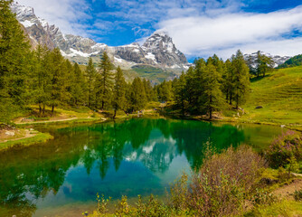 Breuil-Cervinia (Italy) - A view of Cervinia mountain town with Cervino mount peak of Alps, trekking paths and Lago Blu touristic lake. In Valle d'Aosta region, north Italy.