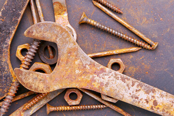 old rusty repair tools on black background. Background of old rusty tools. The concept of workshop or repair 
