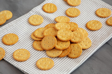 Round Crispy Crackers with Sea Salt on a gray background, side view.