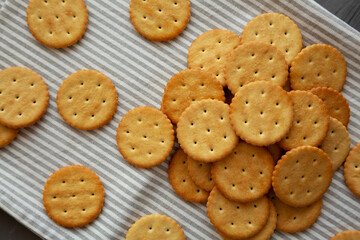Round Crispy Crackers with Sea Salt on a gray background, top view.