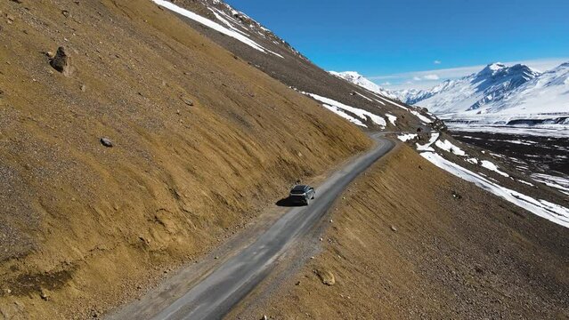aerial drone following car driving in Kaza in spiti valley in himalays india hight mountains road travel destination 