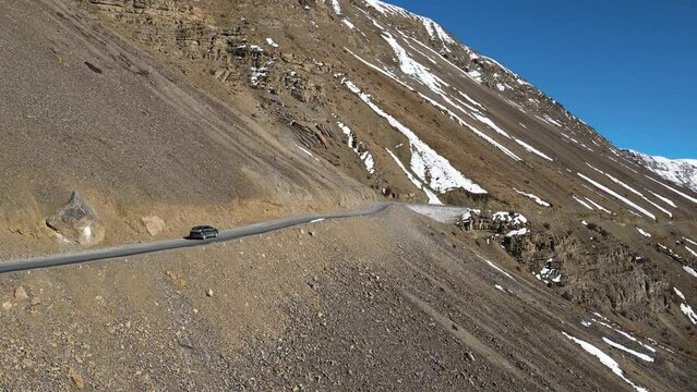 aerial following a off road jeep car driving in Kaza in spiti valley in himalays India 