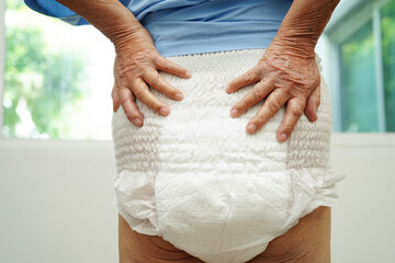 Asian senior woman patient wearing adult incontinence diaper pad in hospital. - obrazy, fototapety, plakaty