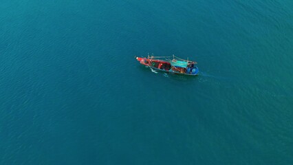 Top view of fishing boat in caribbean sea looking for fish. Endless Caribbean sea beckons fishermen in search of good fish catch. Come on vacation to Caribbean to take boat trip to catch seafood.