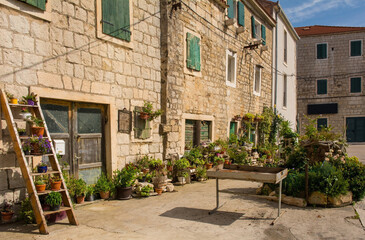 Fototapeta na wymiar Old stone houses in the historic centre of Kastel Kambelovac in Kastela on the mainland of Croatia