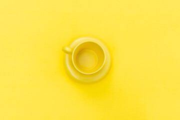 yellow cup of coffee on a yellow background