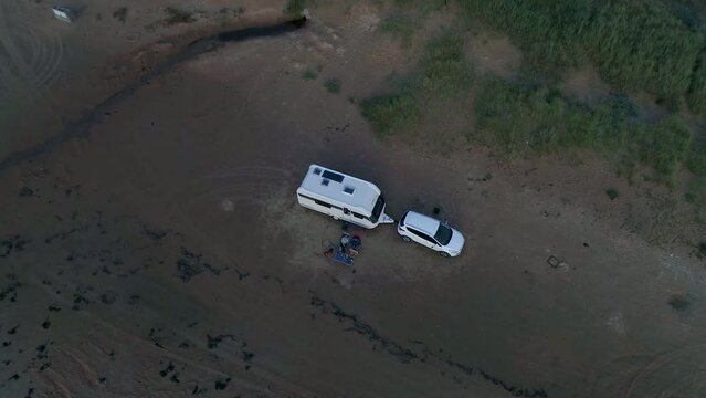 50fps aerial Sunset Couple with dog on Outdoor vacation caravan campsite camper on Melby beach, Sweden by the ocean
