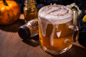 Pumpkin spice latte in a glass mug