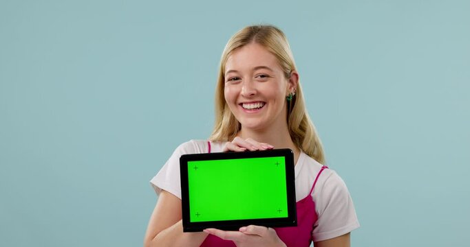 Happy woman, face or green screen on a tablet for social media advertising or online branding. Blue background, smile or portrait of gen z student showing app chroma key or mockup space in studio