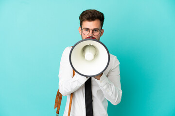 Business man over isolated background shouting through a megaphone