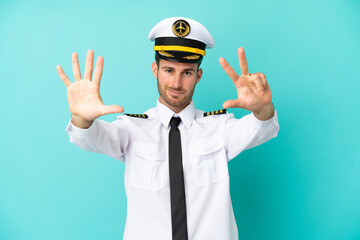 Airplane caucasian pilot isolated on blue background counting eight with fingers