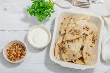 Dumplings, filled with cabbage. Fried onion, fresh sour cream. Traditional Ukrainian dish