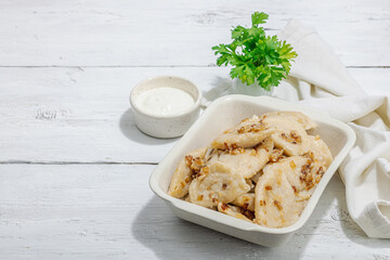 Dumplings, filled with cabbage. Fried onion, fresh sour cream. Traditional Ukrainian dish