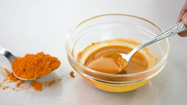 Turmeric paste in a glass bowl.