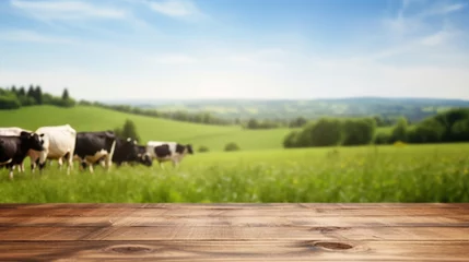 Rolgordijnen Empty wooden table top with blur background of cows pasture © tashechka