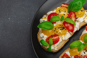 Fresh bread sandwiches with tomato cherry, cream cheese and basil leaves. Morning breakfast concept