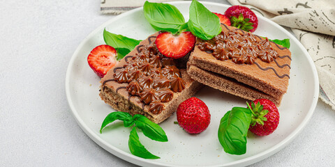 Delicious chocolate cakes with fresh strawberries. Sweet dessert, good morning concept