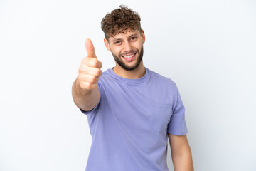 Young handsome caucasian man isolated on white background with thumbs up because something good has happened