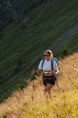 Girl with a backpack hiking in the evening light