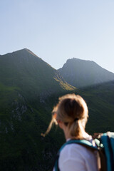 Girl with a backpack hiking in the evening light