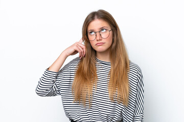 Young caucasian woman isolated on white background making the gesture of madness putting finger on...