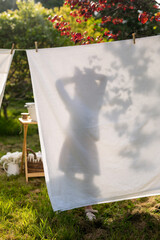 Silhouette of a child through a white sheet, laundry theme