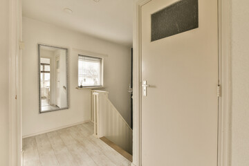 an empty room with white walls and wood flooring on the left side of the room, there is a chalk board that says