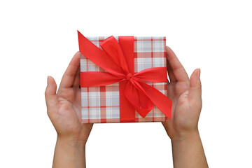 Gift box with a red bow and female hands on transparent background, top view