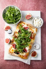 Homemade pizza with figs and arugula
