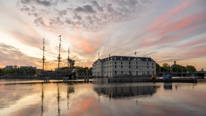 Sunrise over canal in Amsterdam with ship