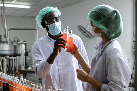 Drink beverage factory QC audit staff quality control worker team working. Hygiene officer clean standard check process inspection in plant production line.