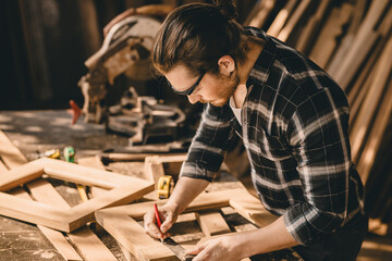 Carpenter Joiner man making wooden furniture in wood workshop professional high skill real authentic handcrafted working people.