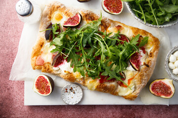 Homemade pizza with figs and arugula