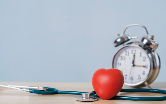 Heart placed next to watch and stethoscope and a text entry area for concept ideas. Time and health, health insurance, family health care Access to health benefits and insurance and world heart day