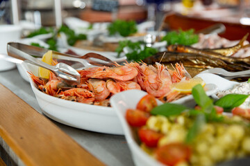 delicious shrimp on a serving plate on the buffet table in the restorant. Seafood buffet lunch in a cafe