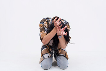 A pathetic and fearful young asian man bowing down and begging to be spared. Isolated on a white background.