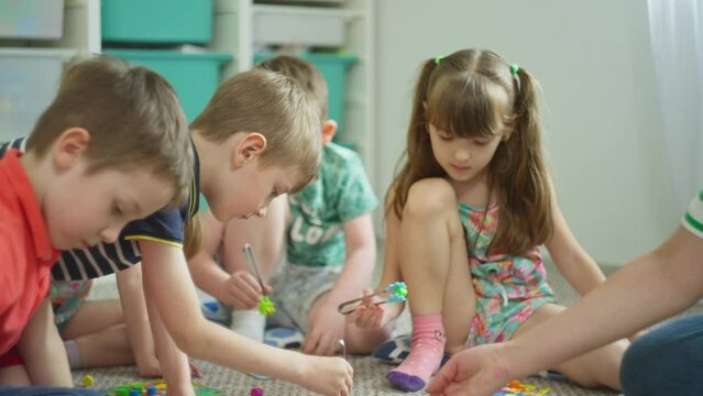 Children perform a creative task with interest. Preparation for school in developmental classes. High quality 4k footage