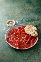 Traditional beef carpaccio with baguette bread