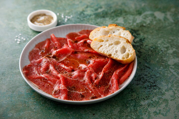 Traditional beef carpaccio with baguette bread