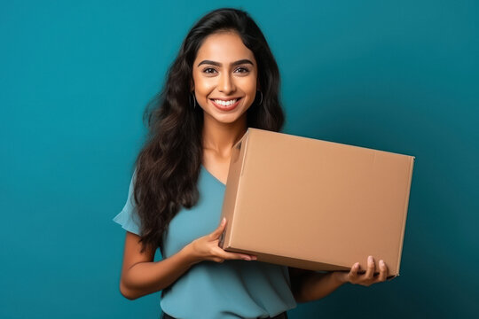 Young woman holding box in hand and giving happy expression