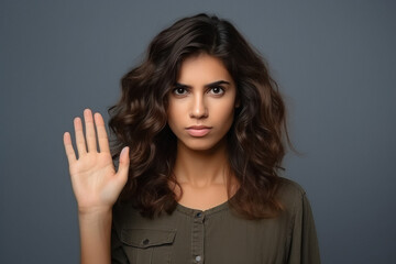 Young woman giving sad expression and saying Hello, Hi or Bye, waving hand.
