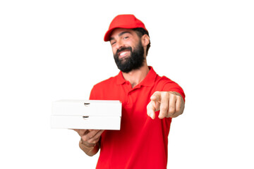 Pizza delivery man with work uniform picking up pizza boxes over isolated chroma key background...