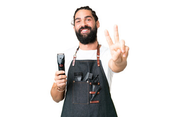 Young barber man over isolated chroma key background smiling and showing victory sign