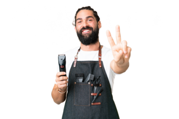 Young barber man over isolated chroma key background smiling and showing victory sign