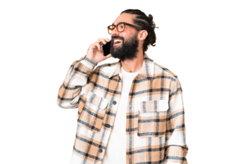 Young man with beard over isolated chroma key background keeping a conversation with the mobile phone