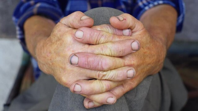 Close-up of the calloused and wrinkled hands of an old man. The concept of old age is the hard work of aging people. High quality 4k footage
