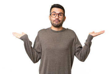 Young handsome caucasian man over isolated background having doubts while raising hands