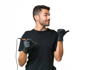 Tattoo artist caucasian man over isolated background pointing to the side to present a product