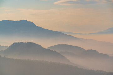 A house in the mountains and garden on a cloudy and foggy day